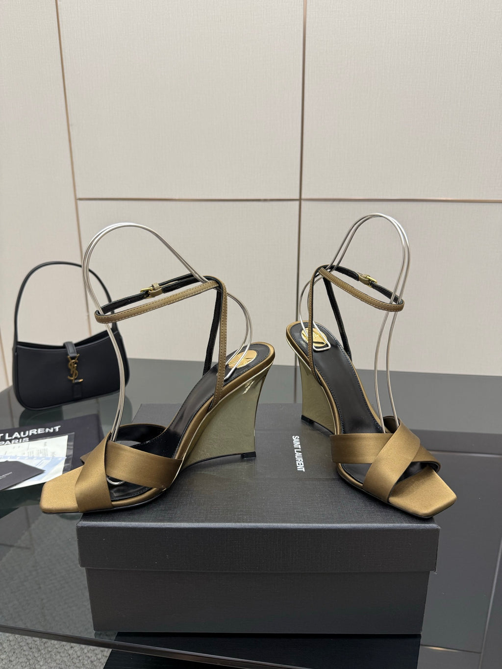 Gold open-toe heeled sandals with gold toe straps and silver ankle straps
