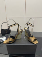 Gold open-toe heeled sandals with gold toe straps and silver ankle straps