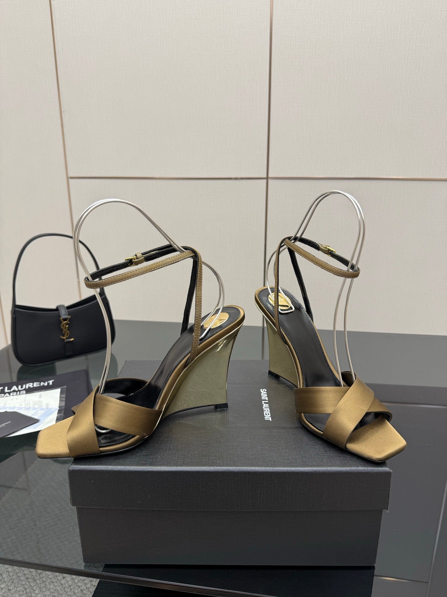 Gold open-toe heeled sandals with gold toe straps and silver ankle straps
