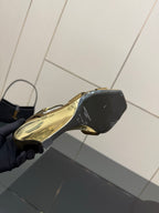 Gold open-toe heeled sandal showing black heel and outsole side