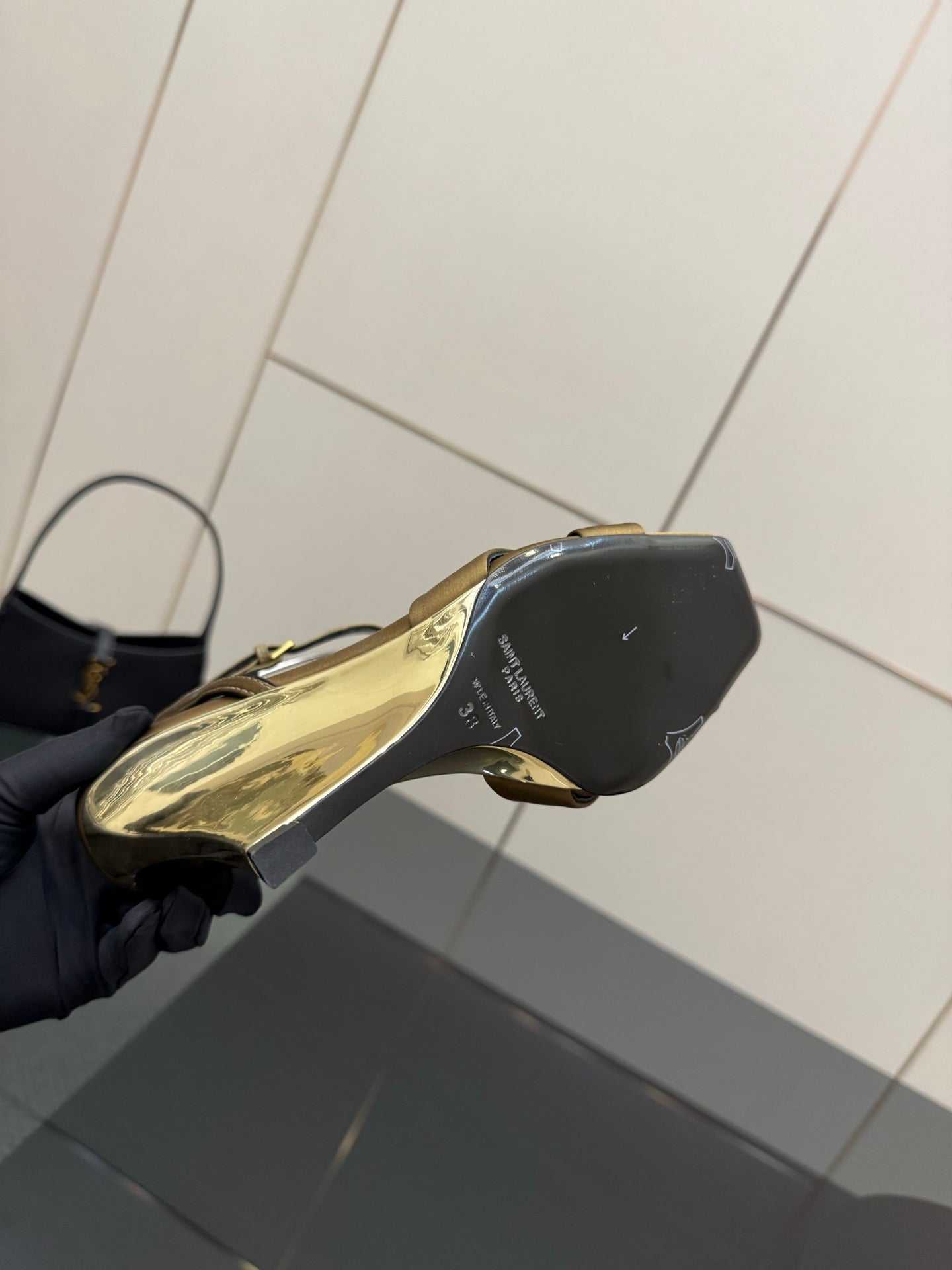 Gold open-toe heeled sandal showing black heel and outsole side