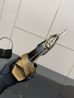 Gold open-toe heeled sandal with silver ankle strap detail and black lining