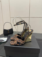Women's high-heel sandals with leopard-print fabric straps and clear ankle loops, side view.