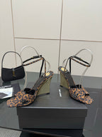 Women's high-heel sandals with leopard-print straps and clear ankle loops, pair on box.