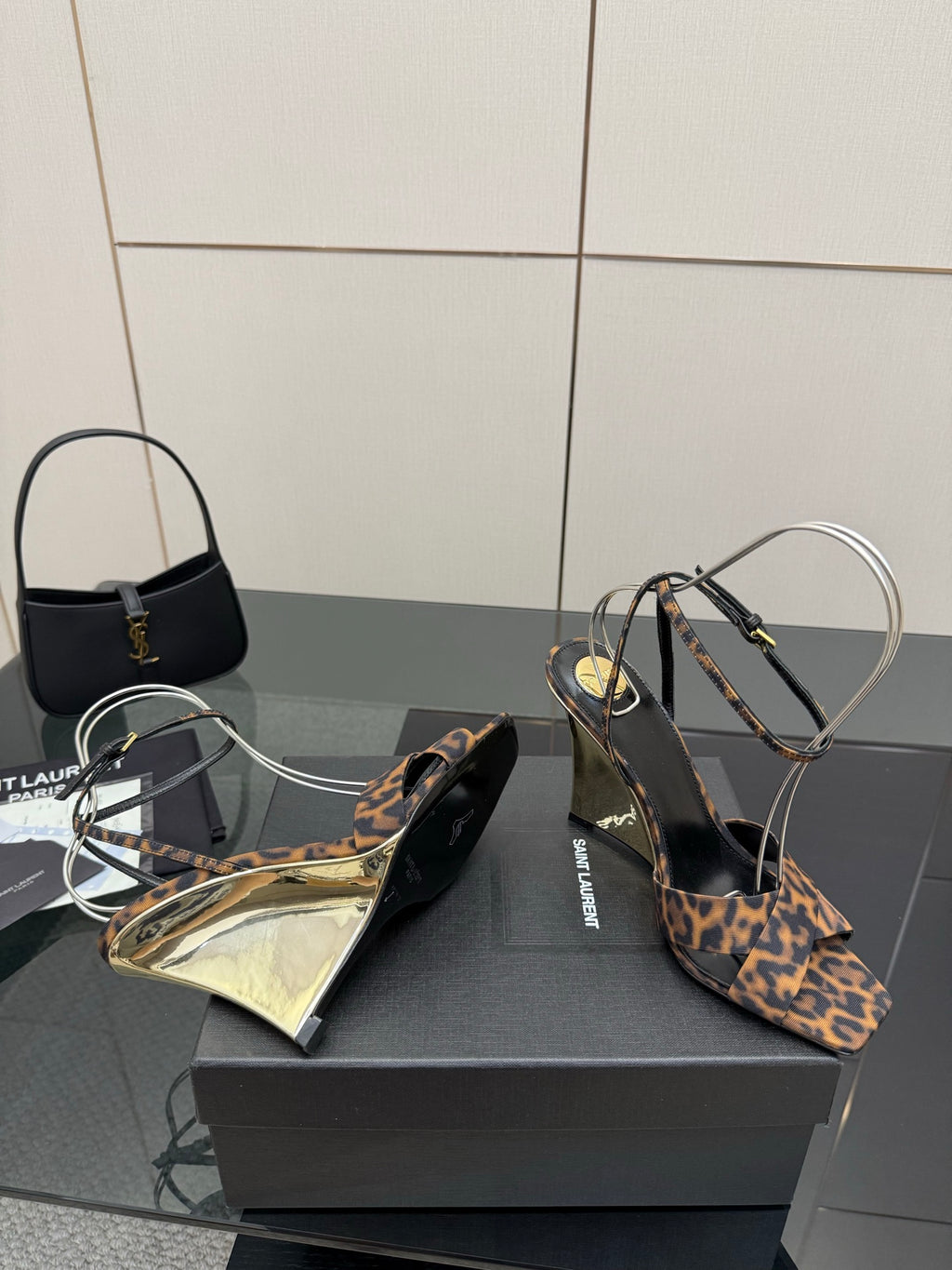 Women's high-heel sandals with leopard-print fabric upper, clear ankle loops, open-toe view.