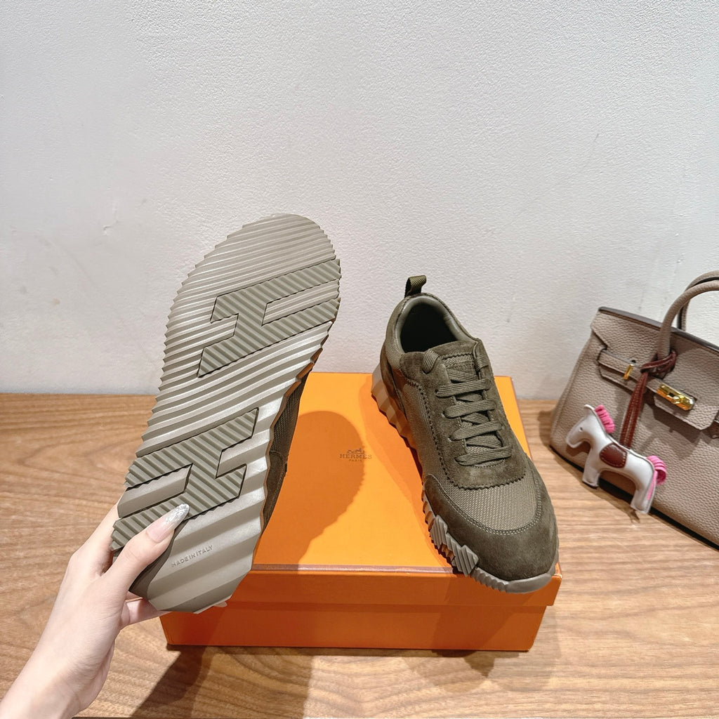 Hermes unisex sneakers with visible outsole tread, olive canvas uppers and lace-up design