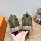 Hermes unisex sneakers rear view: olive canvas uppers with padded heel and chunky sole