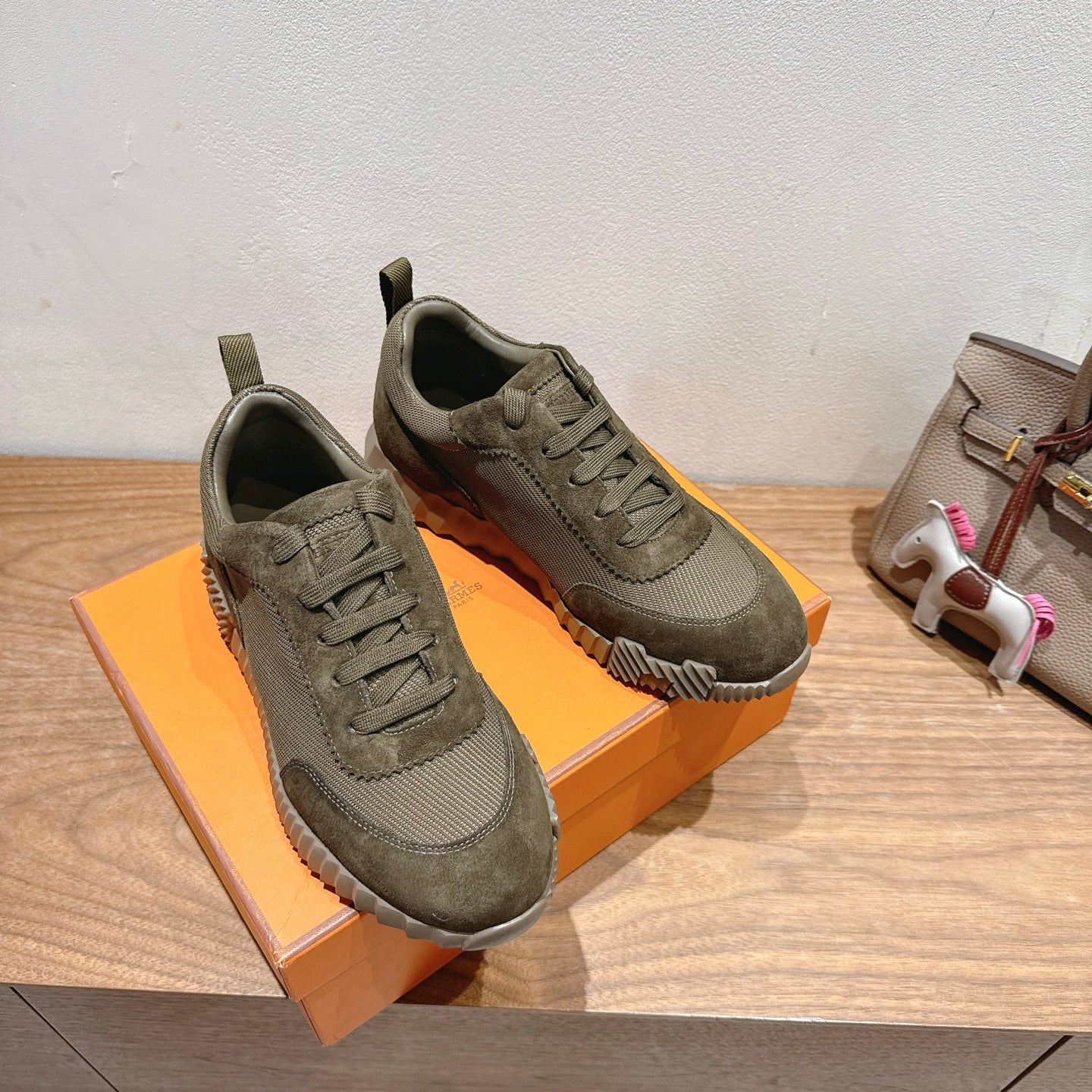 Hermes unisex sneakers in olive canvas, lace-up style with thick sole and side tread detail