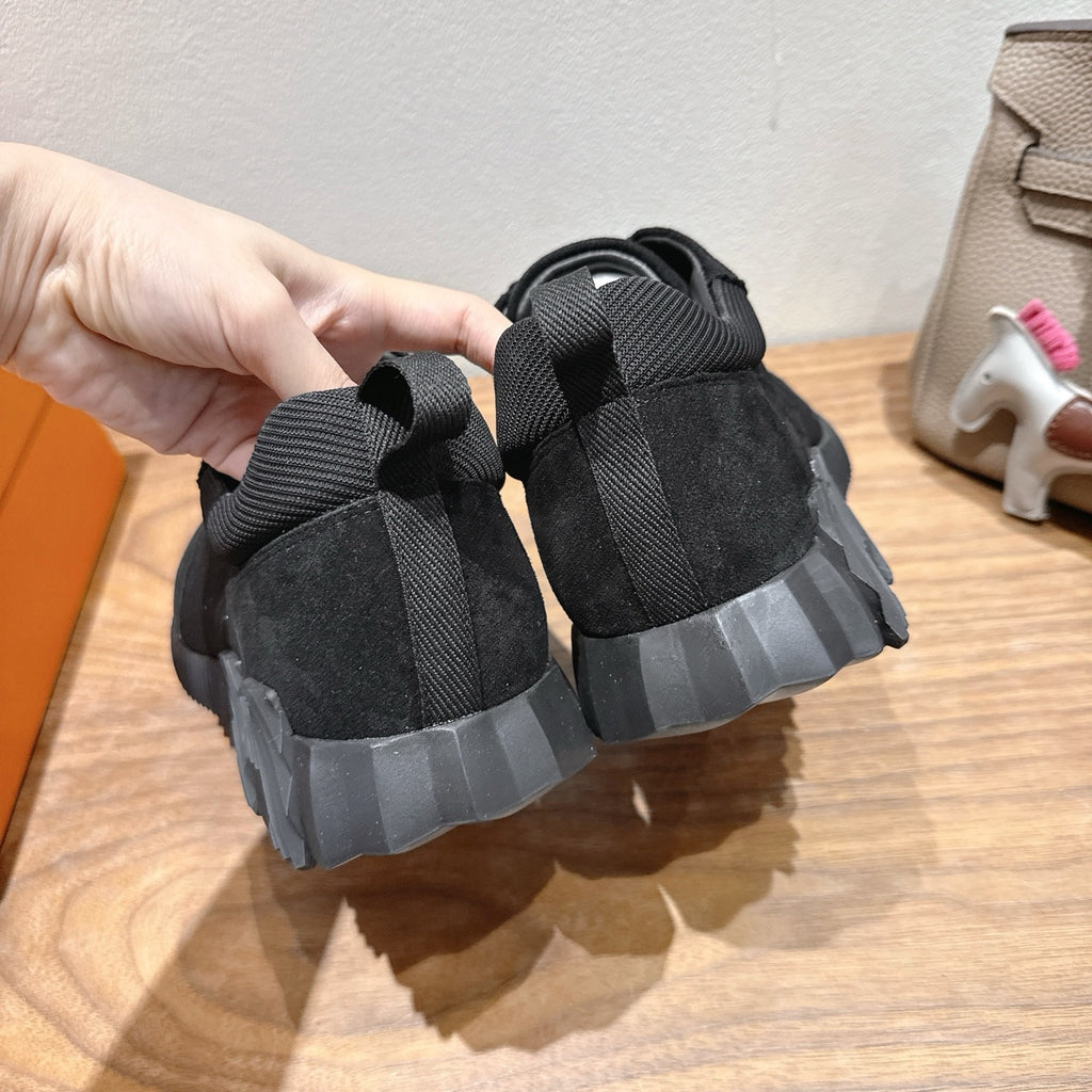 Hermes unisex sneakers, black lace-up rear view with ribbed heel and tread detail