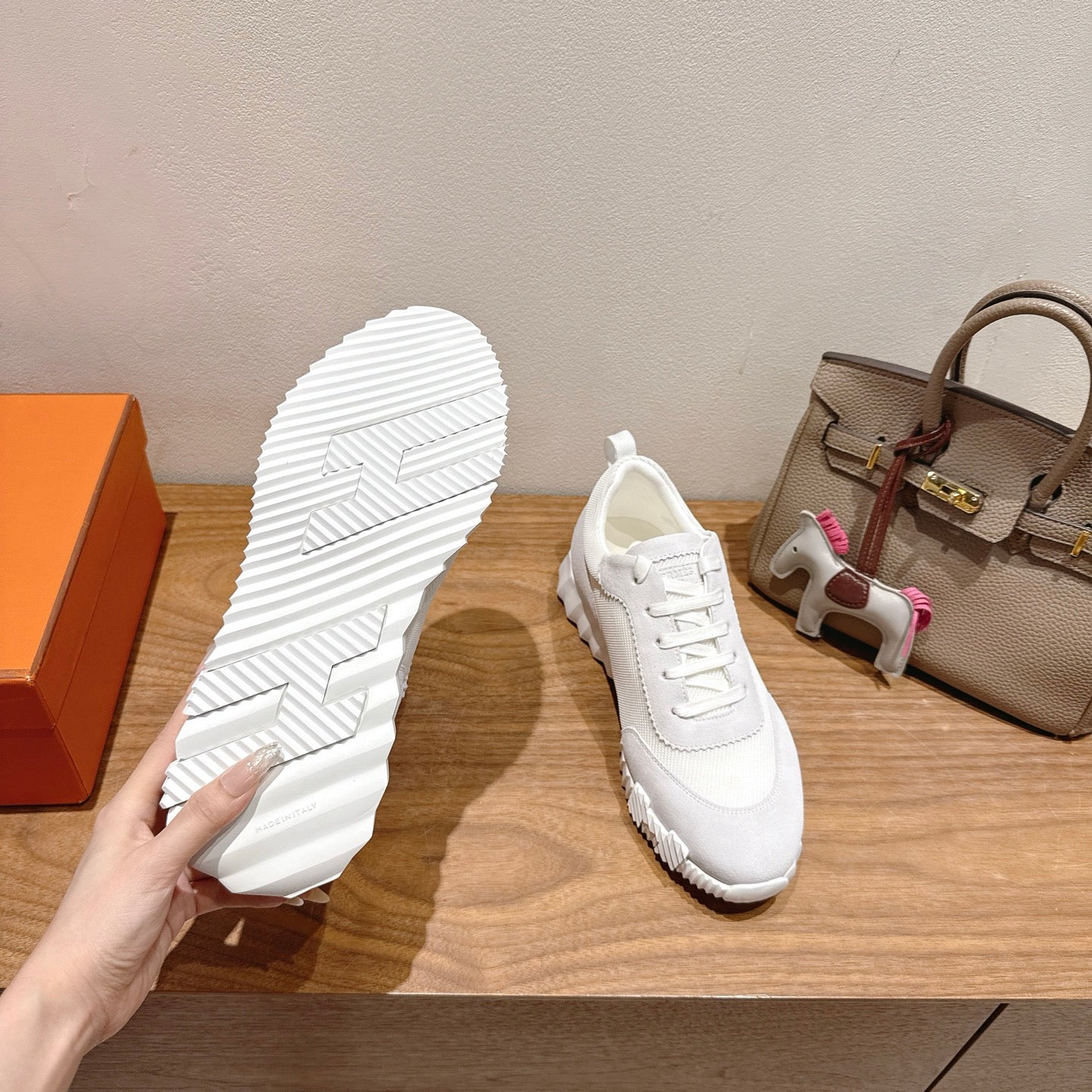 Hermes white unisex sneakers, outsole view, textured tread on rubber sole