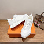 Hermes white unisex sneakers, close-up of laces and layered midsole