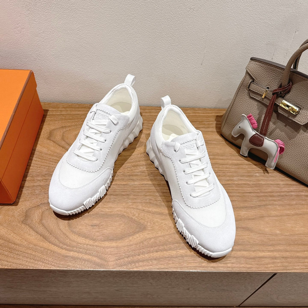 Hermes white unisex sneakers, side view, lace-up over chunky ribbed sole