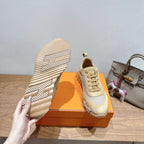 Hermes sneakers with one sole facing up, cream and light gray uppers