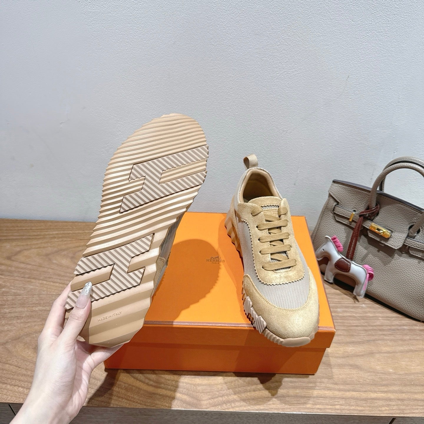 Hermes sneakers with one sole facing up, cream and light gray uppers