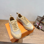 Hermes lace-up sneakers with cream suede overlays and light gray mesh panels