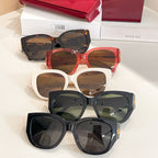 Set of Gucci sunglasses with black, red, and white frames; separate pairs stacked.