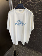 White short-sleeve T-shirt with blue Dior “for my real friends” graphic on front