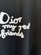 Close-up of white Dior “for my real friends” graphic on black short-sleeve T-shirt