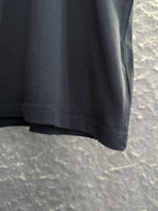 Black short-sleeve T-shirt hem with visible stitching at bottom edge