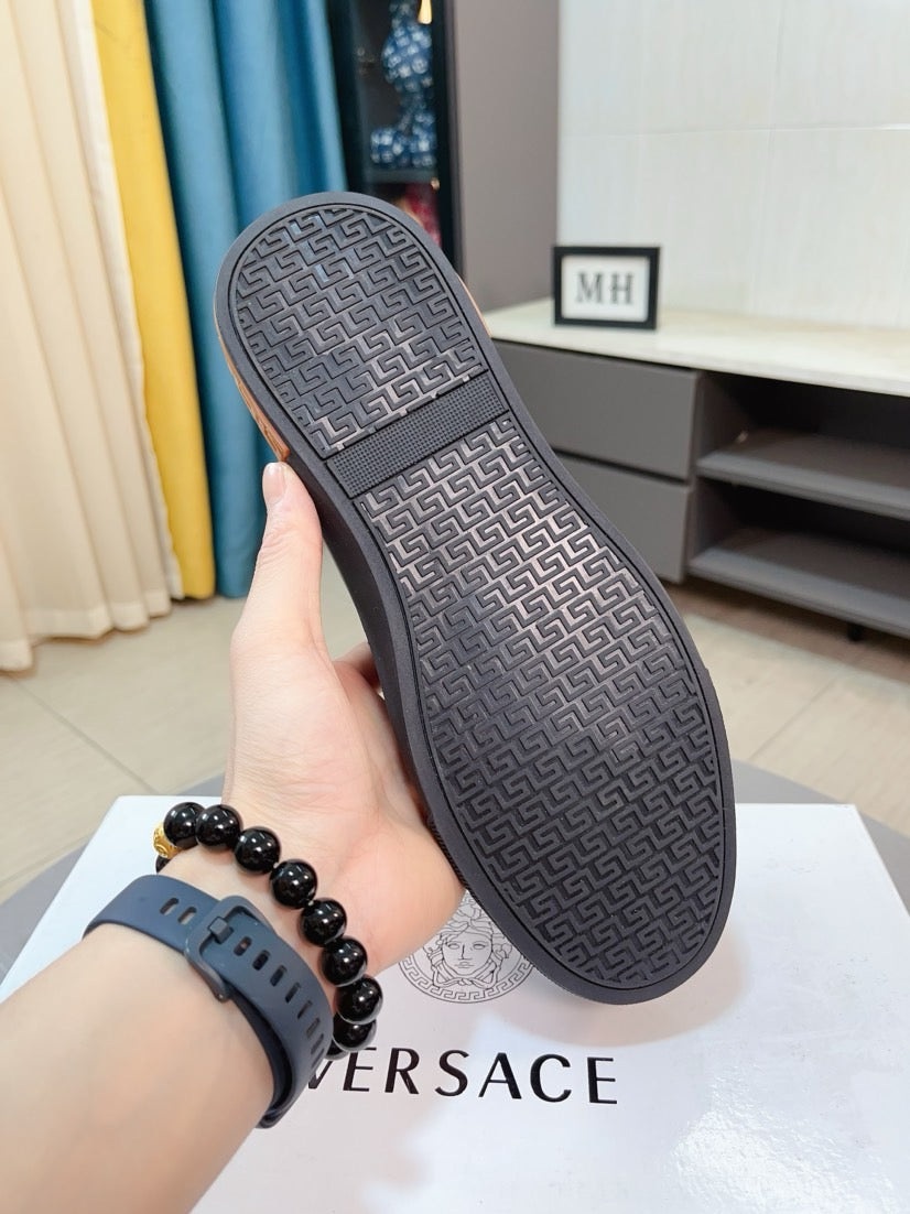 Versace sneakers outsole view, dark gray rubber with repeating logo pattern