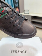 Versace sneakers close-up, dark brown leather lace-up with striped collar detail
