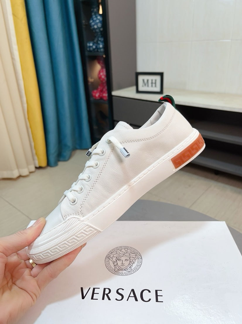 Versace white sneakers with orange heel stripe and embossed side detailing