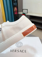 Versace white sneakers with orange outsole edge and red green stripe trim
