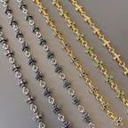 Star charm bracelet links in silver and gold with blue and green accents