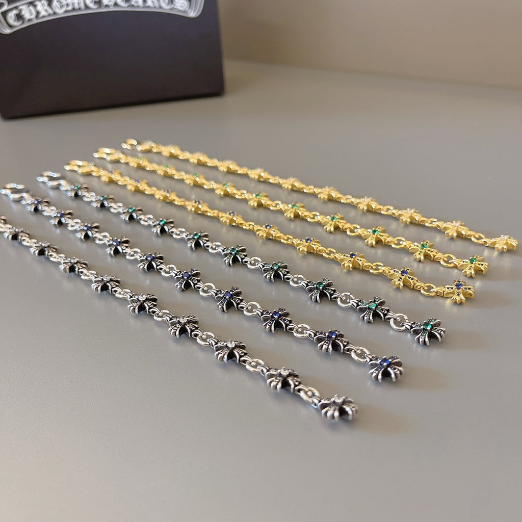 Long charm bracelets with silver and gold chain links and blue or green stones
