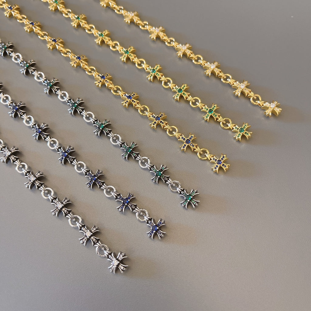 Bracelet links with star charms in gold, silver, blue, and green stones