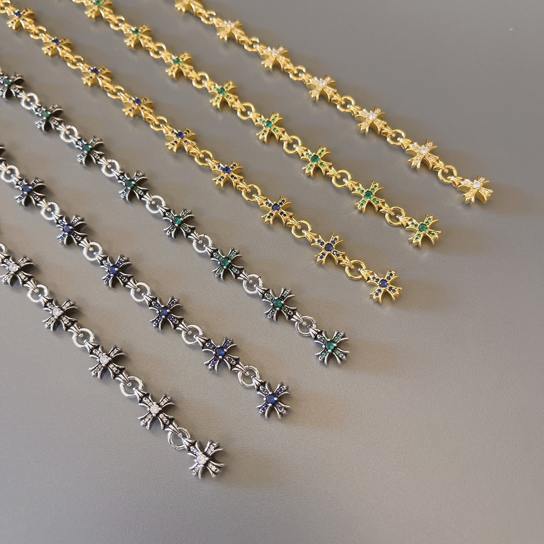 Bracelet links with star charms in gold, silver, blue, and green stones