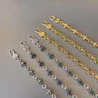 Charm bracelet set with gold and silver links and blue-green star charms