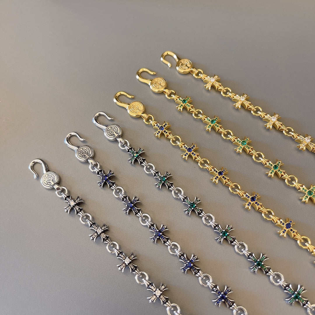 Charm bracelet set with gold and silver links and blue-green star charms