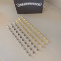 Charm bracelet set with gold, silver, blue, and green star links