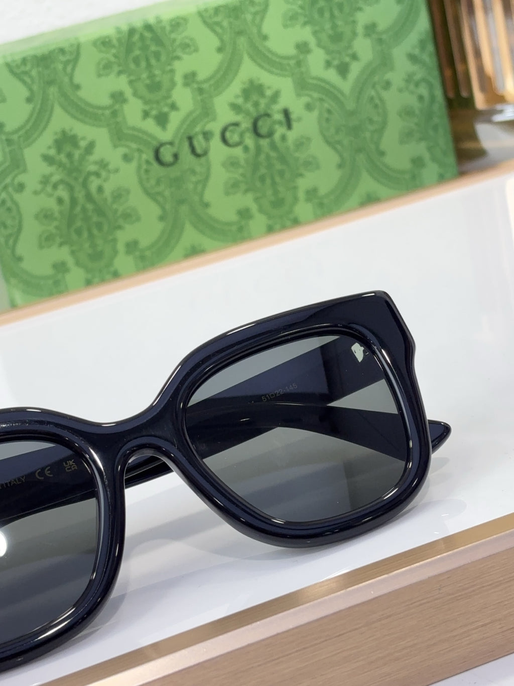 Gucci sunglasses side view with dark navy frame and large dark lenses