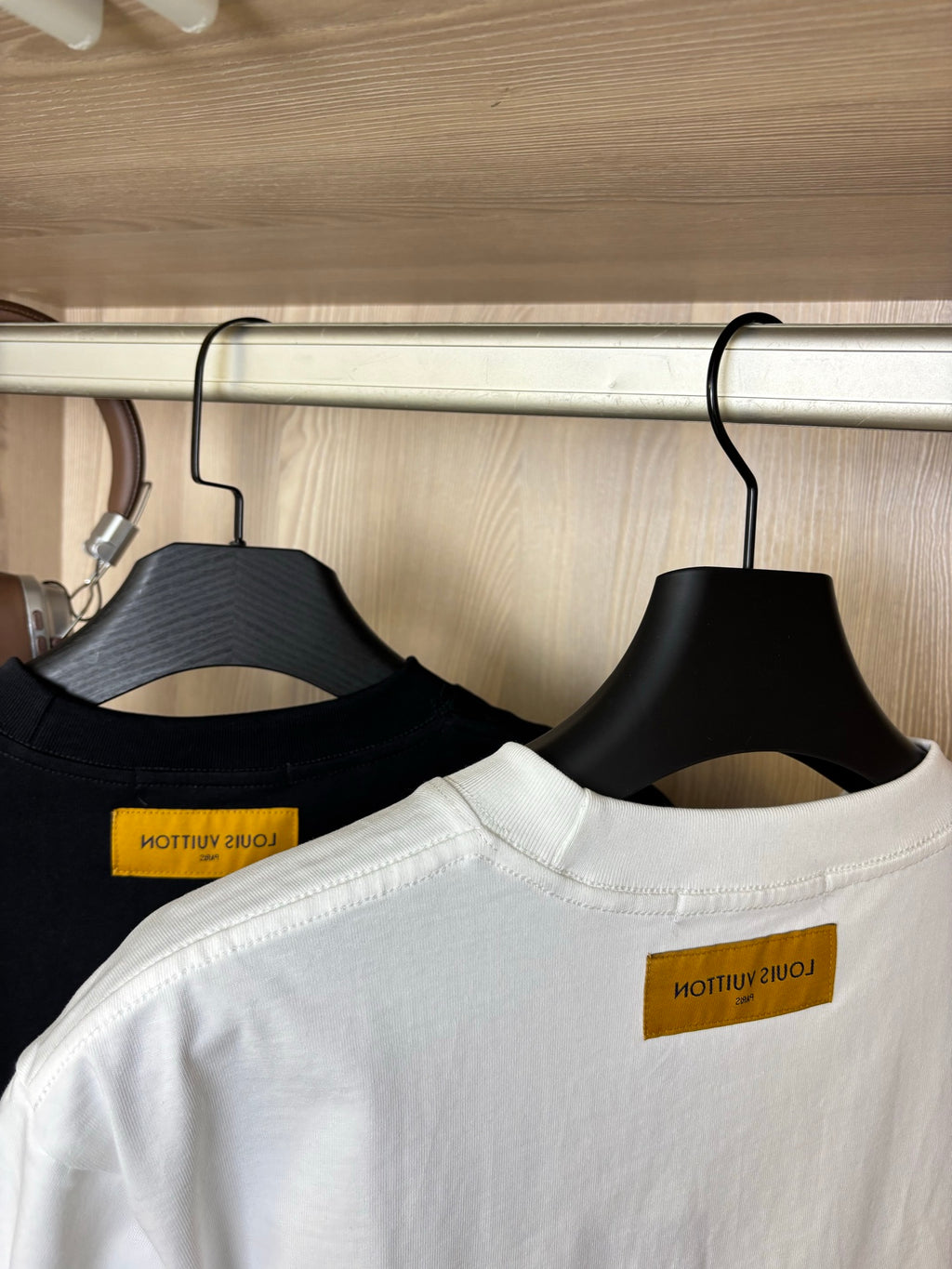 Crewneck T-shirts close-up: black and white collars with yellow inner labels