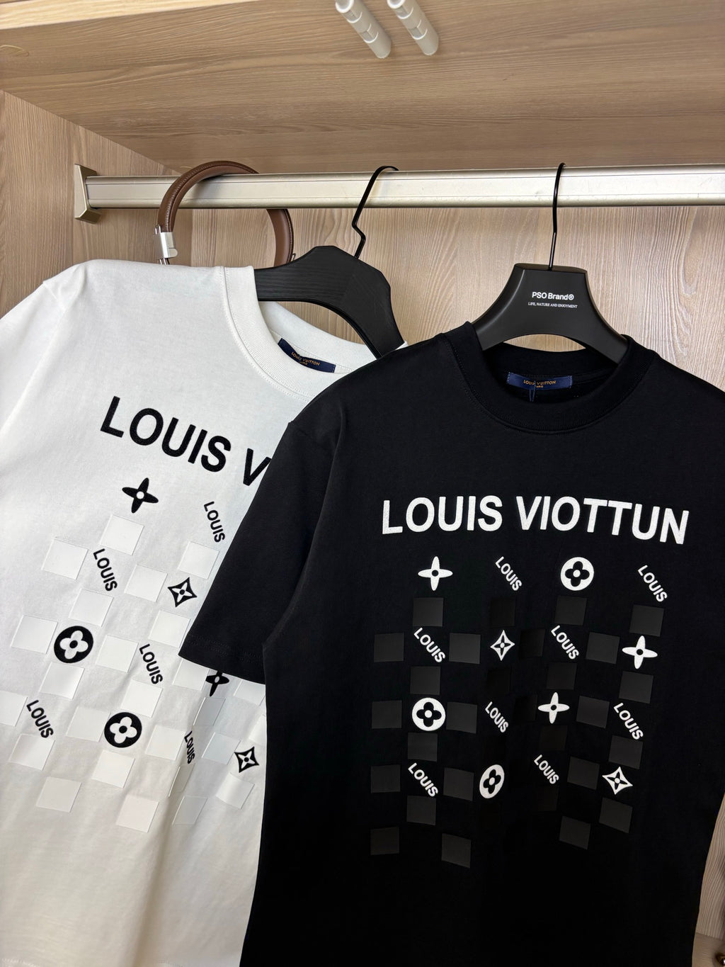 White and black crewneck T-shirts with “LOUIS VIOTTVN” chest graphics
