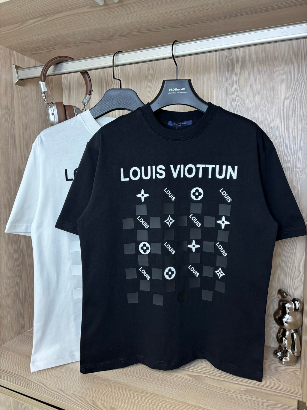 Black crewneck T-shirt with “LOUIS VIOTTVN” graphic and icons on chest