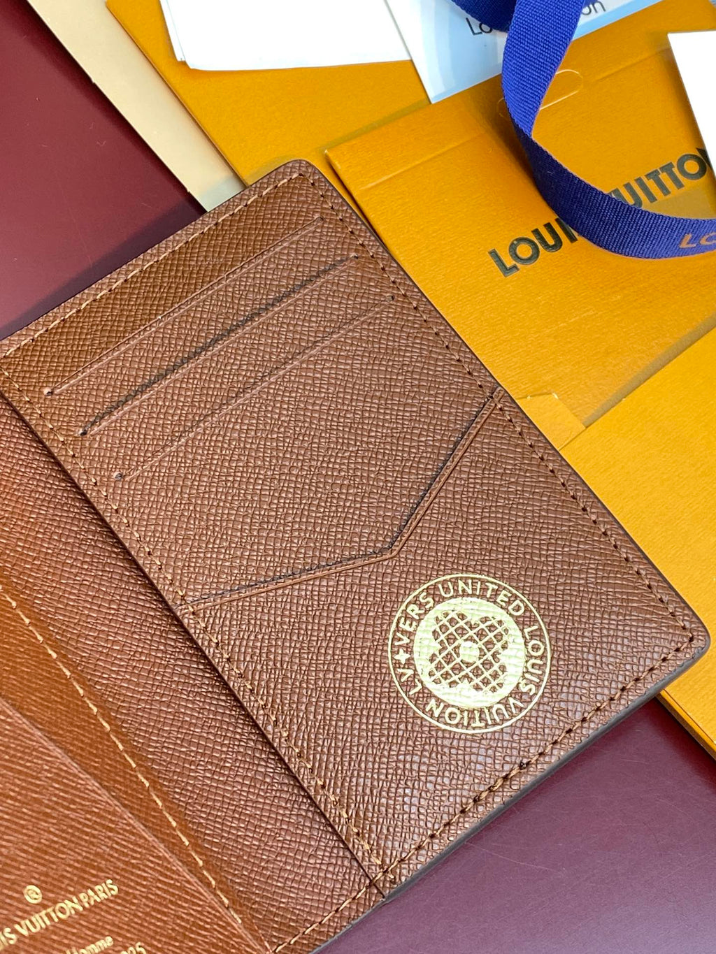Louis Vuitton textured small wallet with logo medallion and stitched flap panel