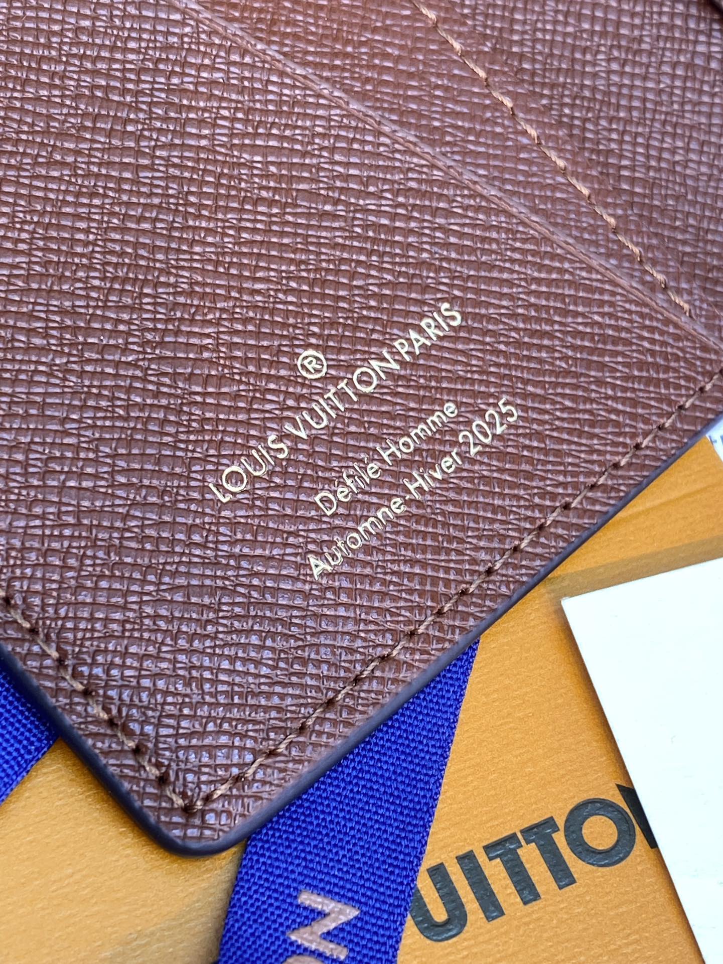 Louis Vuitton textured leather wallet panel with embossed logo and decorative stitching