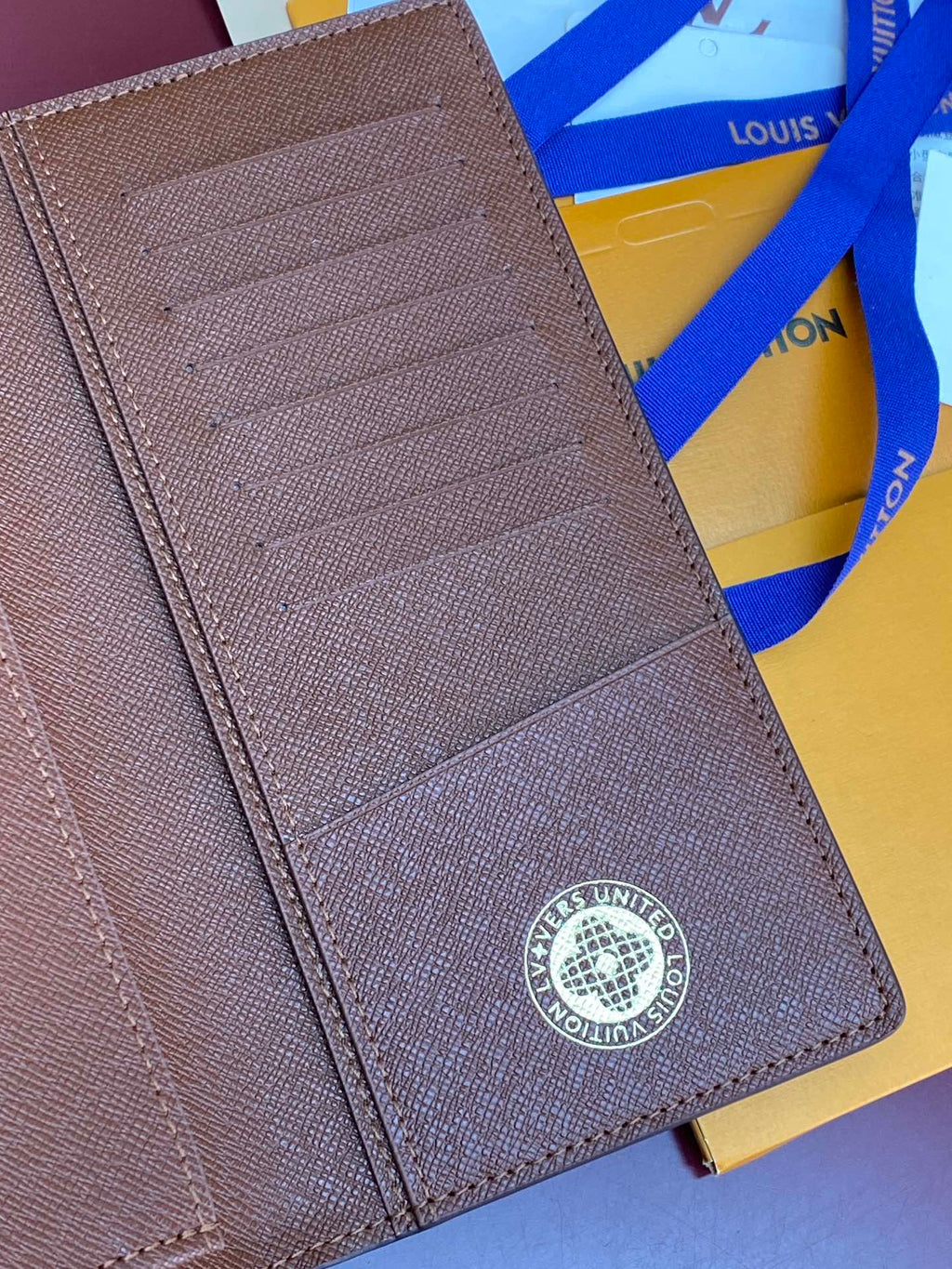 Louis Vuitton brown textured small bag with embossed logo patch and card slots