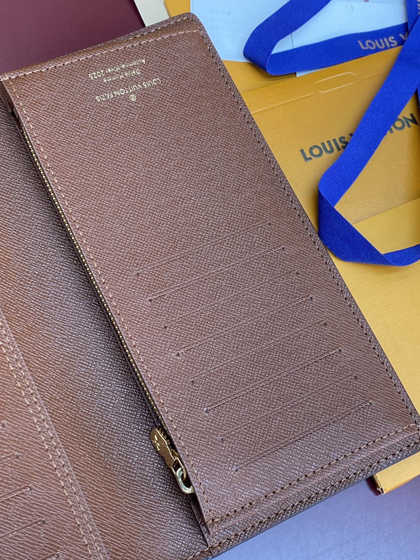 Louis Vuitton brown textured small bag with metal snap detail and card slots