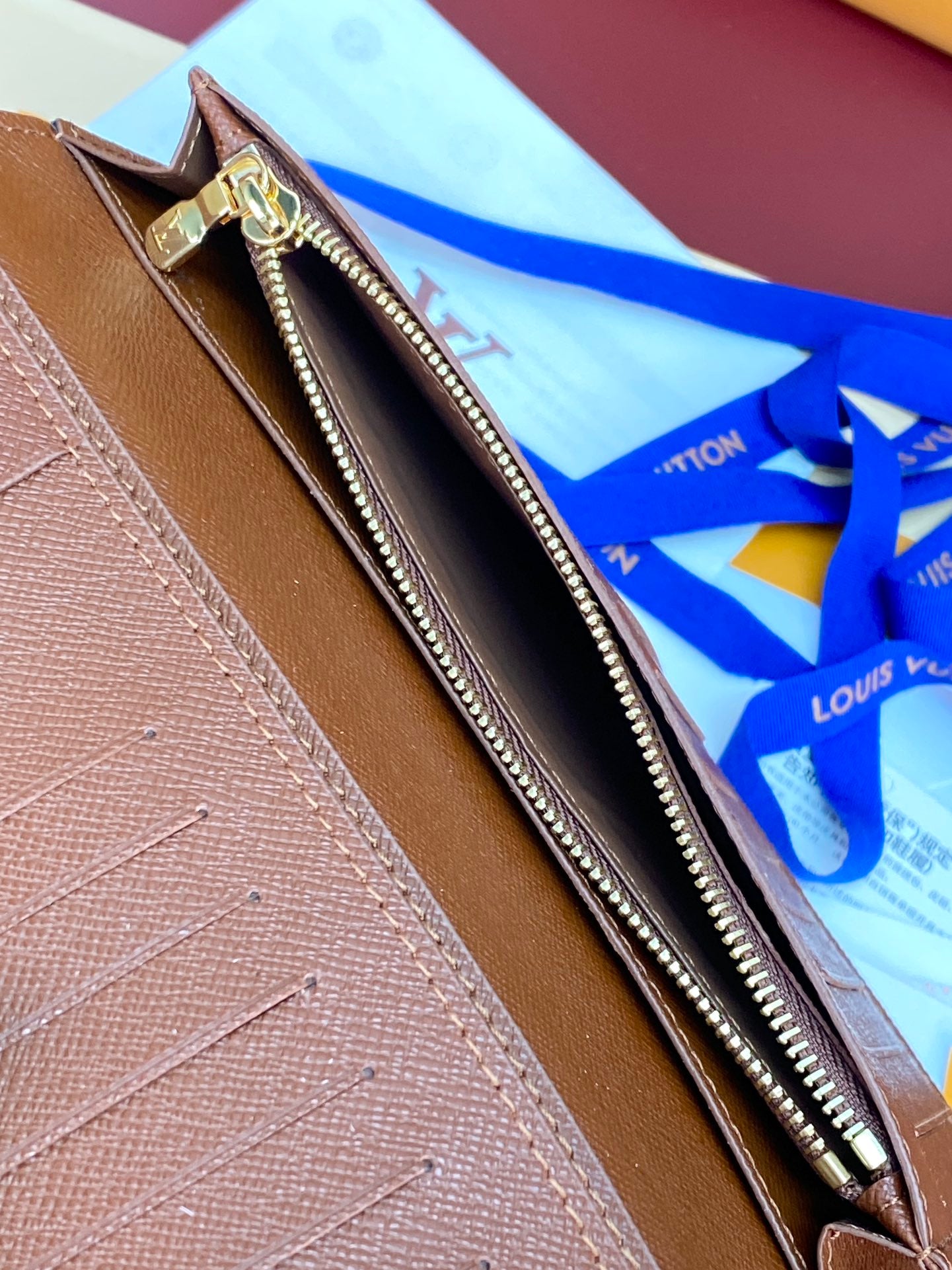 Louis Vuitton brown textured small bag interior with zipper and gold-toned trim