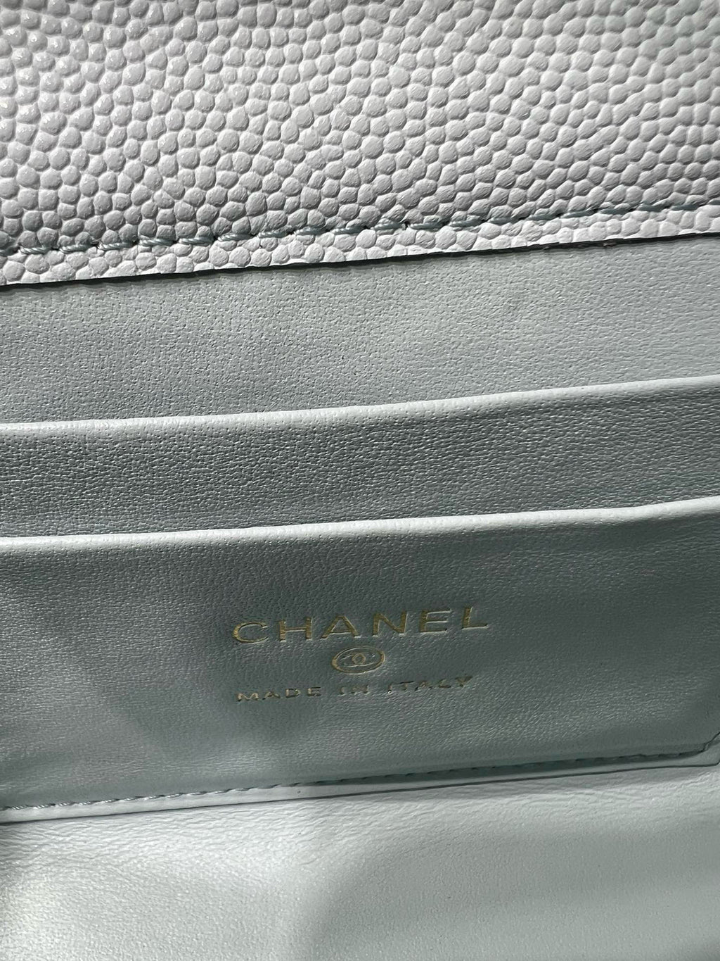 Chanel logo embossed on light blue quilted bag leather