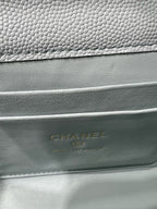 Chanel logo embossed on light blue quilted bag leather