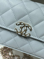 Chanel light blue quilted flap bag close-up of gold chain clasp