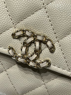 Chanel cream bag front clasp and decorative gold chain hardware detail