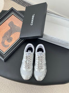Chanel unisex white sneakers, lace-up with side logo, shown with gift box