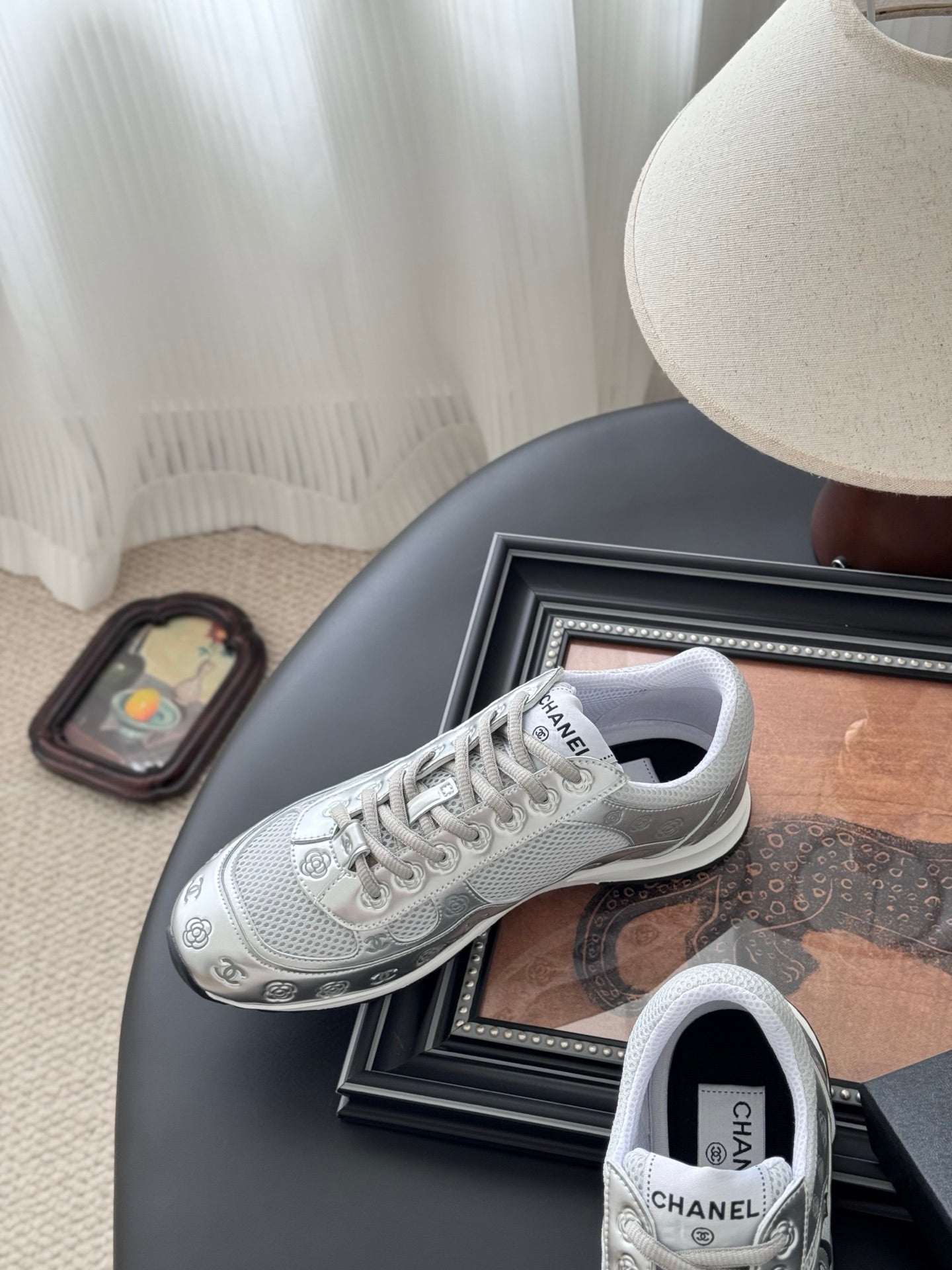 Chanel unisex white sneakers, lace-up front with side logo, near gift box
