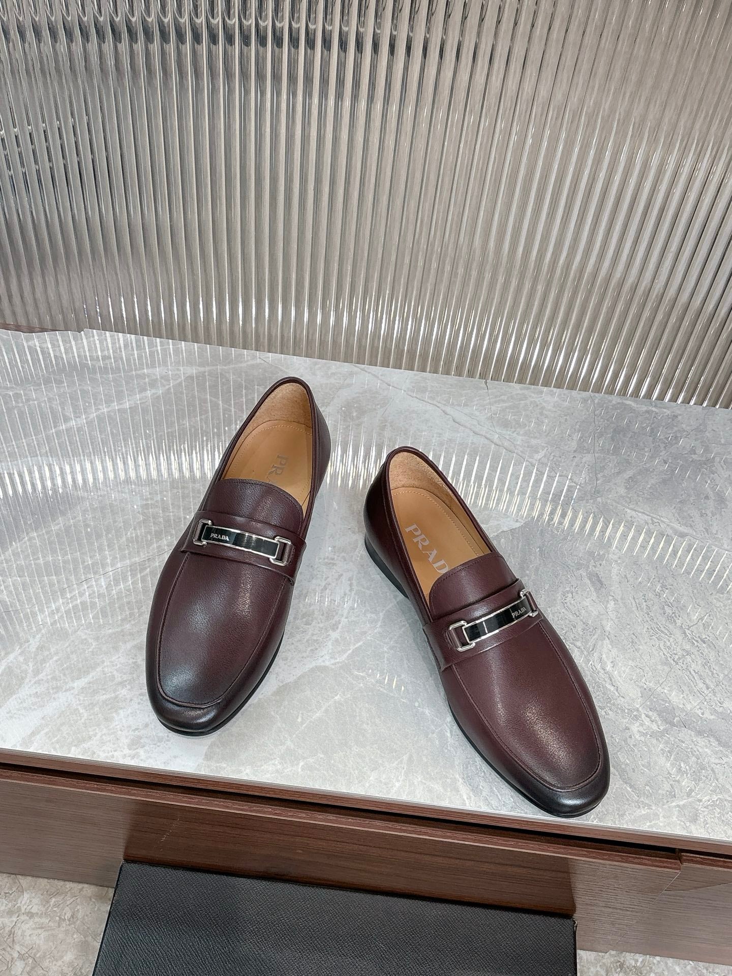 Prada unisex leather loafers, side view, dark burgundy buckle strap